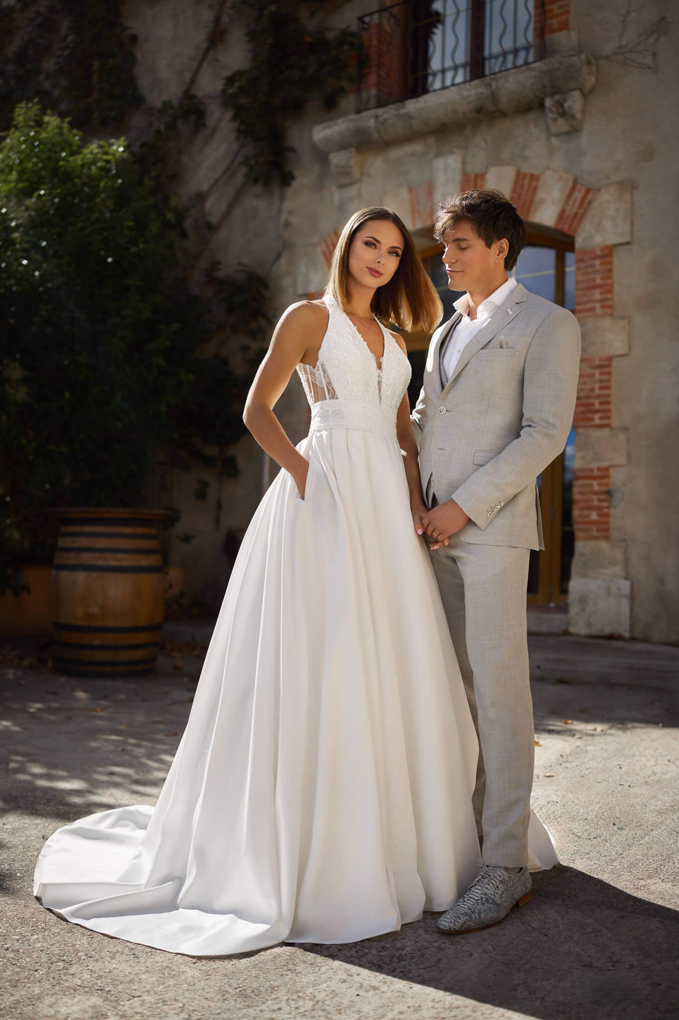 Elegantes Mikado-Brautkleid im modernen A-Linien-Stil mit tiefem V-Ausschnitt, strukturiertem Spitzenoberteil und praktischen Eingriffstaschen, exklusiv fotografiert für das Brautmodenstudio Cuxhaven.